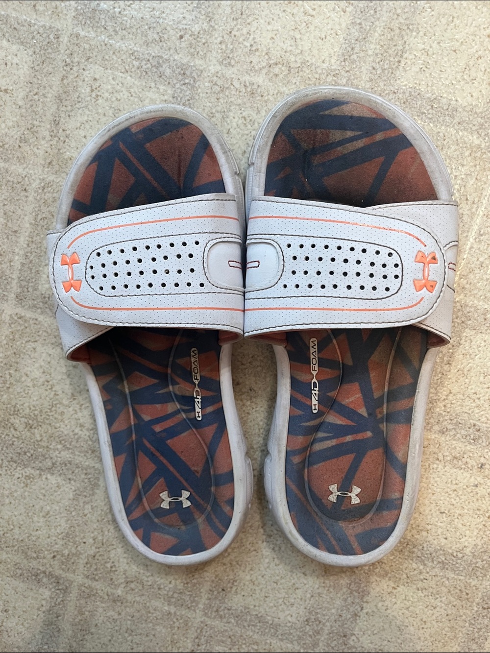 Under Armour White Slide Sandals with Orange Accents and Patterned Footbed